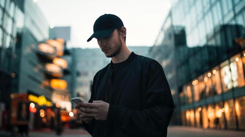 A boy using mobile on while walking