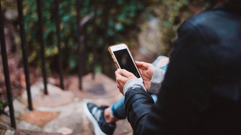 a person sitting somewere and using mobile